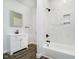 A beautifully renovated bathroom with white marble tile, modern vanity and a black fixture shower at 238 N Tacoma Ave, Indianapolis, IN 46201