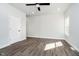 Bright bedroom featuring plank flooring, a ceiling fan, and a window at 238 N Tacoma Ave, Indianapolis, IN 46201