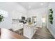Bright kitchen featuring white cabinets, a granite island with seating, and stainless steel appliances at 238 N Tacoma Ave, Indianapolis, IN 46201