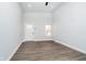 Open living area with sleek flooring, a bright white door, and abundant natural light creating an airy feel at 238 N Tacoma Ave, Indianapolis, IN 46201
