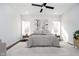 Spacious main bedroom with large windows and ceiling fan, neutral paint, and plush carpeting at 238 N Tacoma Ave, Indianapolis, IN 46201
