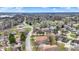 Expansive aerial view of a suburban neighborhood with well-maintained homes and green spaces under a partly cloudy sky at 3051 Arrow Wood Ln, Indianapolis, IN 46214