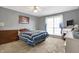 Comfortable bedroom featuring soft carpet, a large window, and a coordinated color scheme at 3051 Arrow Wood Ln, Indianapolis, IN 46214