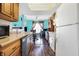Open layout with a view of the kitchen and dining area, featuring wood cabinets and white appliances at 3051 Arrow Wood Ln, Indianapolis, IN 46214