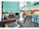 Inviting living room with a stone fireplace, a flatscreen TV, and views of the adjacent dining and kitchen areas at 3051 Arrow Wood Ln, Indianapolis, IN 46214