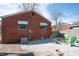 Brick house backyard with a fire pit, gravel, and lawn at 311 S Webster Ave, Indianapolis, IN 46219
