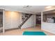 Unfinished basement with painted brick walls and stairs, with a painted floor at 311 S Webster Ave, Indianapolis, IN 46219