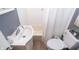 Cozy bathroom with a white vanity, toilet, and shower/tub combination at 311 S Webster Ave, Indianapolis, IN 46219