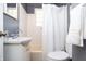 Cozy bathroom featuring a white vanity, toilet, and a shower/tub combination with white tile at 311 S Webster Ave, Indianapolis, IN 46219