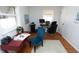 Bright bedroom with hardwood floors featuring a desk and chair and two windows allowing plenty of natural light at 311 S Webster Ave, Indianapolis, IN 46219