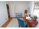 Bright bedroom with hardwood floors, a red desk, and two windows providing natural light with neutral walls at 311 S Webster Ave, Indianapolis, IN 46219