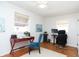 Bright bedroom with hardwood floors featuring a desk and chair and two windows allowing plenty of natural light at 311 S Webster Ave, Indianapolis, IN 46219