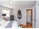 Bright bedroom featuring hardwood floors, a large window, and an ornate decorative mirror at 311 S Webster Ave, Indianapolis, IN 46219
