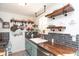 Updated kitchen with wood counters, tiled backsplash, and stainless steel appliances at 311 S Webster Ave, Indianapolis, IN 46219