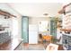 Eat-in kitchen with brick flooring, butcher block countertops and custom shelving at 311 S Webster Ave, Indianapolis, IN 46219
