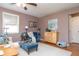 Comfortable living area with a ceiling fan, natural light, and coordinated decor including a plush chair and accent furniture at 311 S Webster Ave, Indianapolis, IN 46219