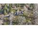 Aerial view of a charming home and shed nestled in a tree-lined landscape at 3357 Saddle Club Rd, Greenwood, IN 46143