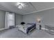 Spacious bedroom with gray walls, neutral carpet, large window, and stylish furnishings at 3357 Saddle Club Rd, Greenwood, IN 46143