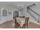 Inviting dining room with hardwood floors, chandelier, and decorative wallpaper at 3357 Saddle Club Rd, Greenwood, IN 46143