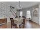 Dining area with hardwood floors, floral wallpaper, and bright natural light at 3357 Saddle Club Rd, Greenwood, IN 46143