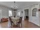 Dining area with classic wallpaper, hardwood floors, and modern chandelier at 3357 Saddle Club Rd, Greenwood, IN 46143