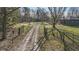 Elegant gated driveway leading to a house and shed on a well-manicured lawn at 3357 Saddle Club Rd, Greenwood, IN 46143