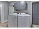 Convenient laundry room with modern washer and dryer, storage cabinets, and patterned flooring at 3357 Saddle Club Rd, Greenwood, IN 46143