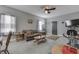 Bright living room featuring gray walls, neutral carpet, ceiling fan, and comfortable seating at 3357 Saddle Club Rd, Greenwood, IN 46143