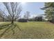 A charming home with a shed and a beautiful lawn surrounded by mature trees at 3357 Saddle Club Rd, Greenwood, IN 46143