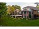 A spacious backyard with a screened in porch and patio with lush green grass at 3727 Tributary Ct, Westfield, IN 46062