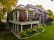 An angled view of a screened in porch with stairs leading to the backyard and landscaped patio at 3727 Tributary Ct, Westfield, IN 46062