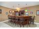 Finished basement bar features dark wood, granite countertops, pendant lighting, and seating at 3727 Tributary Ct, Westfield, IN 46062