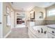 This bathroom features a garden tub surrounded by granite and offers access back to the main bedroom at 3727 Tributary Ct, Westfield, IN 46062