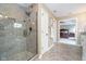 A glass-door shower provides an open and clean space in this attached bathroom with access back to the main bedroom at 3727 Tributary Ct, Westfield, IN 46062