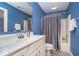 A half bathroom features blue walls, a silver shower curtain, and white fixtures at 3727 Tributary Ct, Westfield, IN 46062