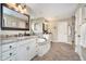 This bathroom features double sinks with granite counters, a soaking tub, and a glass door shower at 3727 Tributary Ct, Westfield, IN 46062