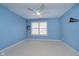 Bright bedroom features a ceiling fan, window, carpet and light-blue colored walls at 3727 Tributary Ct, Westfield, IN 46062