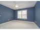 A simple bedroom features blue walls, a ceiling fan, and natural light at 3727 Tributary Ct, Westfield, IN 46062