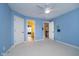 Carpeted bedroom boasts blue walls, ceiling fan, and connections to the bathroom and hallway at 3727 Tributary Ct, Westfield, IN 46062