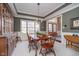 Elegant dining room boasts wainscoting, coffered ceilings, large windows, and a stylish chandelier at 3727 Tributary Ct, Westfield, IN 46062