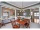 Well-lit dining room boasts wainscoting, decorative ceilings, and hardwood table perfect for entertaining at 3727 Tributary Ct, Westfield, IN 46062