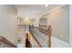 Second-floor hallway showcasing decorative wrought iron railing and neutral decor at 3727 Tributary Ct, Westfield, IN 46062