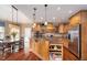 Bright kitchen featuring custom cabinetry, a central island, and a dining area with large windows at 3727 Tributary Ct, Westfield, IN 46062