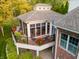 A screened in porch with an outdoor seating area and flower boxes that overlook the manicured yard at 3727 Tributary Ct, Westfield, IN 46062