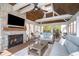 Inviting sunroom boasts a stone fireplace, wood ceiling, and comfortable sofas, perfect for lounging at 3727 Tributary Ct, Westfield, IN 46062