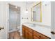 Bathroom with wood cabinets, laminate floors, and shower at 3875 Offshore Dr, Columbus, IN 47203