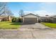 Home exterior with a two car garage, small grassy area and paved driveway at 3875 Offshore Dr, Columbus, IN 47203