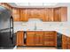 Functional kitchen featuring wood cabinets and black appliances at 3875 Offshore Dr, Columbus, IN 47203