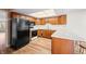 Well-lit kitchen with breakfast bar, black appliances and wooden cabinetry at 3875 Offshore Dr, Columbus, IN 47203