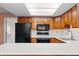 Kitchen with skylight features stainless sink, wood cabinets, and modern appliances at 3875 Offshore Dr, Columbus, IN 47203